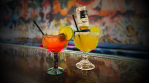 Two margaritas for happy hour promotions for Margaritas at Uno Más