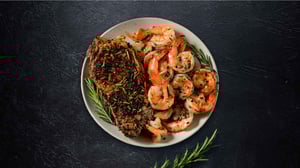A delicious plated steak and shrimp image.