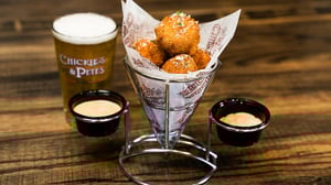 Image of a serving of deep fired crusted Lobster Gold Mine with two sides of spicy mayo and chipotle crema dipping sauce.