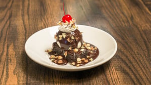 A dessert plate with a brownie hot fudge sundae.