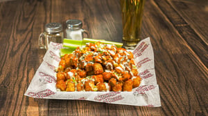 A plate with a serving of Buffalo chicken tots.
