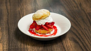 A plate with fresh strawberry shortcake.