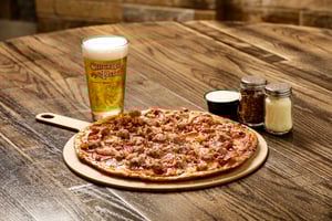 Image of plater with Meat Lovers Pizza and drink.