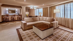 Photo of living area with bar and dining in the Ambassador Suite at Grand Sierra Resort in Reno, Nevada.