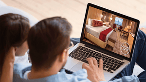 Photo of couple browsing on laptop looking at pictures of Grand Sierra Resort in Reno, NV