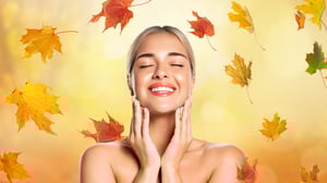 Image of women enjoying spa treatment with fall leaves in the background.